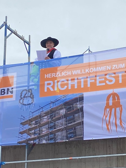 Ein Mann in traditioneller Handwerkerkluft liest etwas von einem Zettel ab. (Bild: LWL/Schufi) (vergrößerte Bildansicht wird geöffnet)